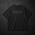 Black t-shirt with 'BRICK CITY' text on a dark textured background