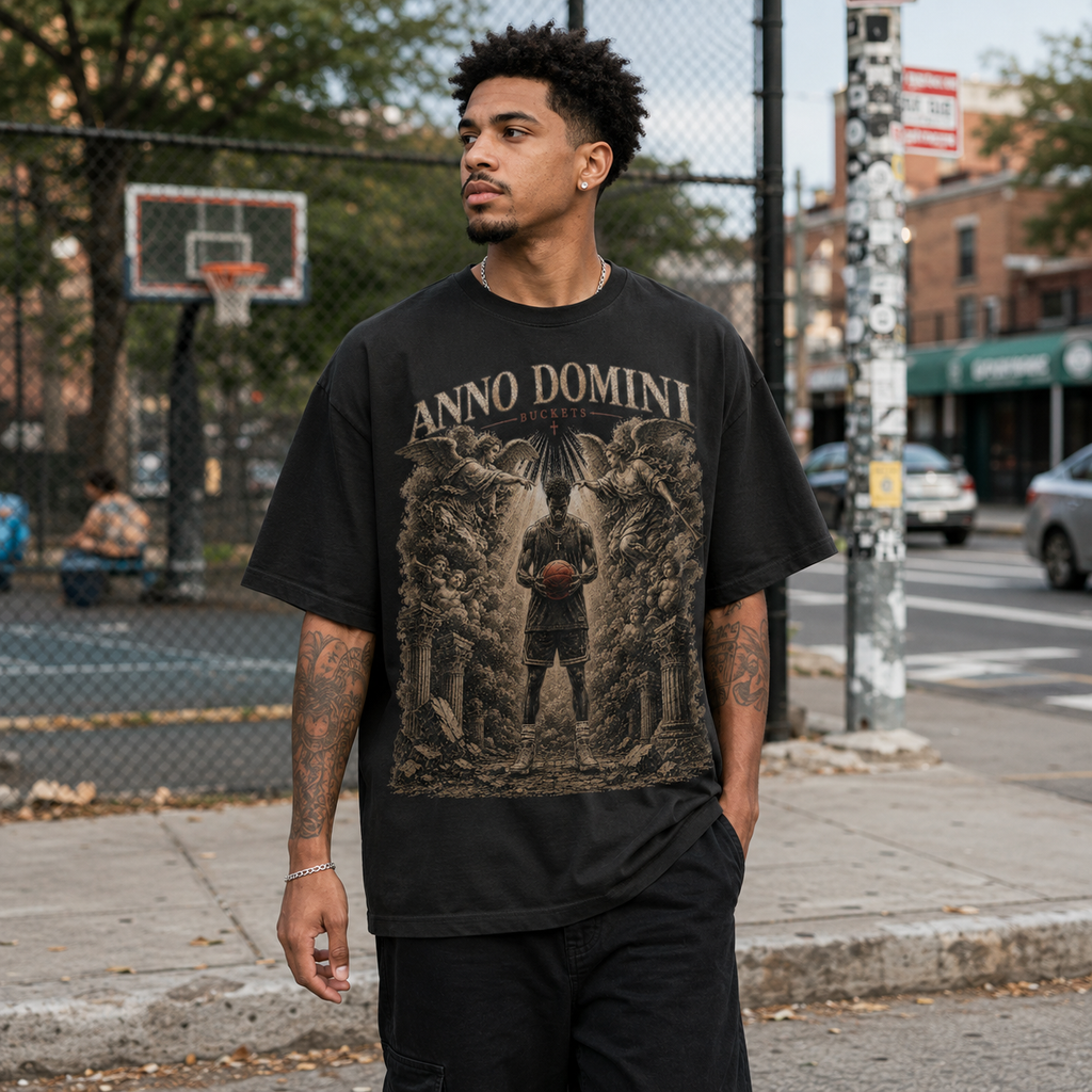 Man wearing a black Bucket Getter graphic t-shirt on a street