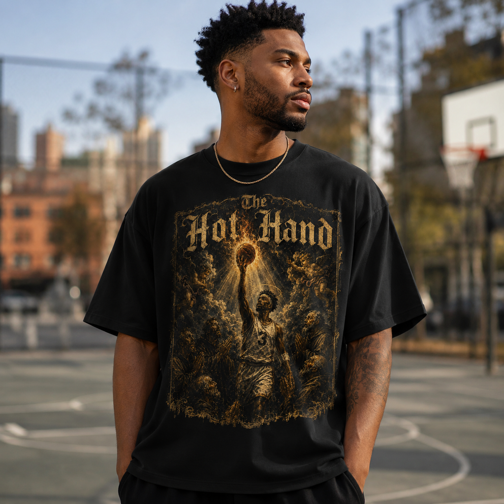 Man wearing a black t-shirt with 'The Hot Hand' graphic on a basketball court.