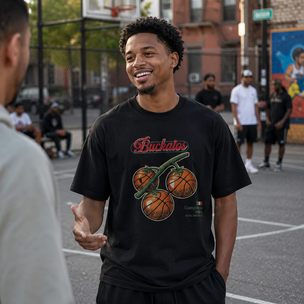 Man wearing a black t-shirt with a graphic design on a basketball court