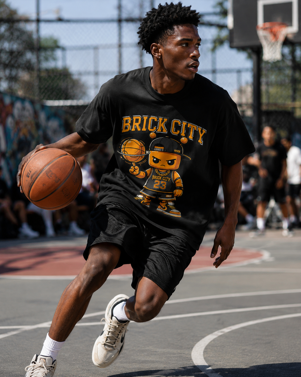 Person playing basketball on an outdoor court wearing a 'Brick City' t-shirt.