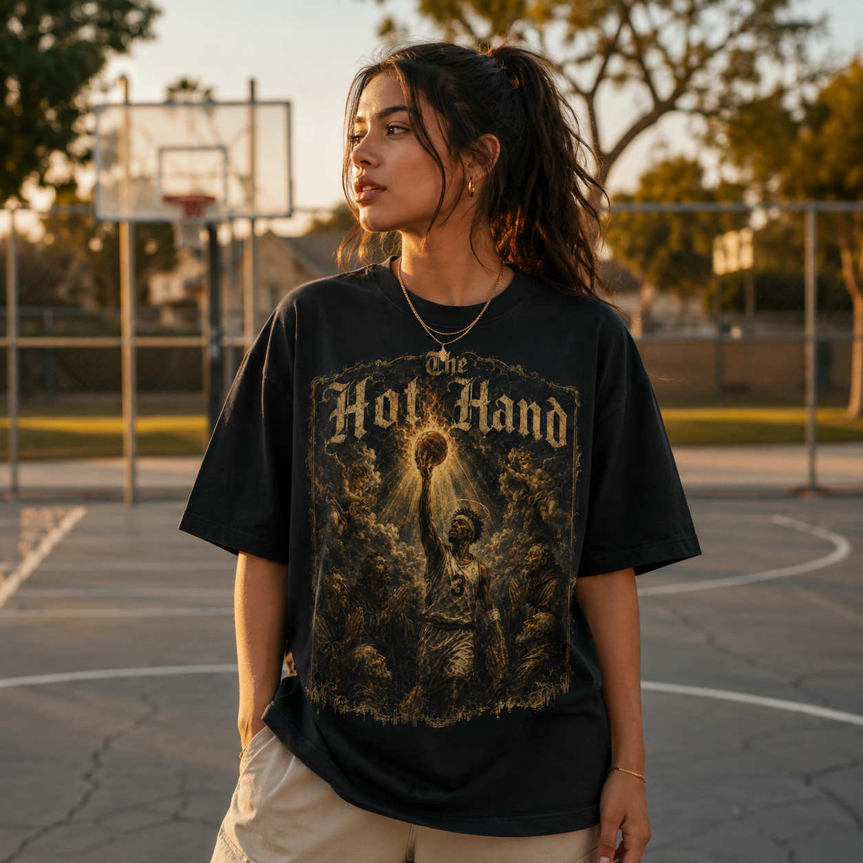 Person wearing a black graphic t-shirt on a basketball court