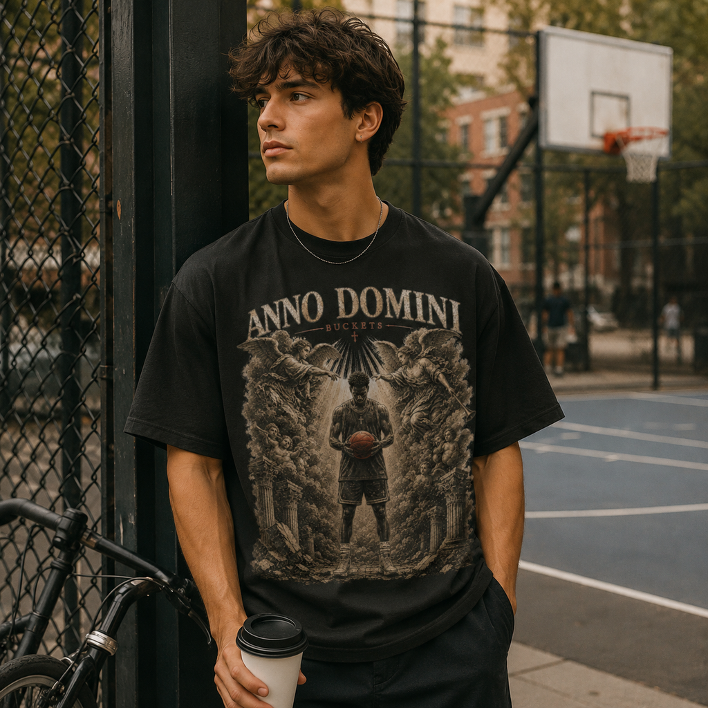 Person wearing a black Bucket Getter t-shirt on a basketball court