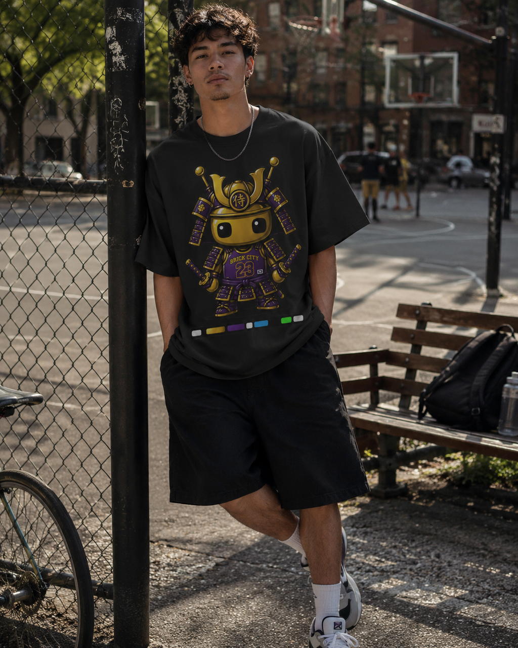 Person wearing a black t-shirt with a colorful graphic design in an urban setting