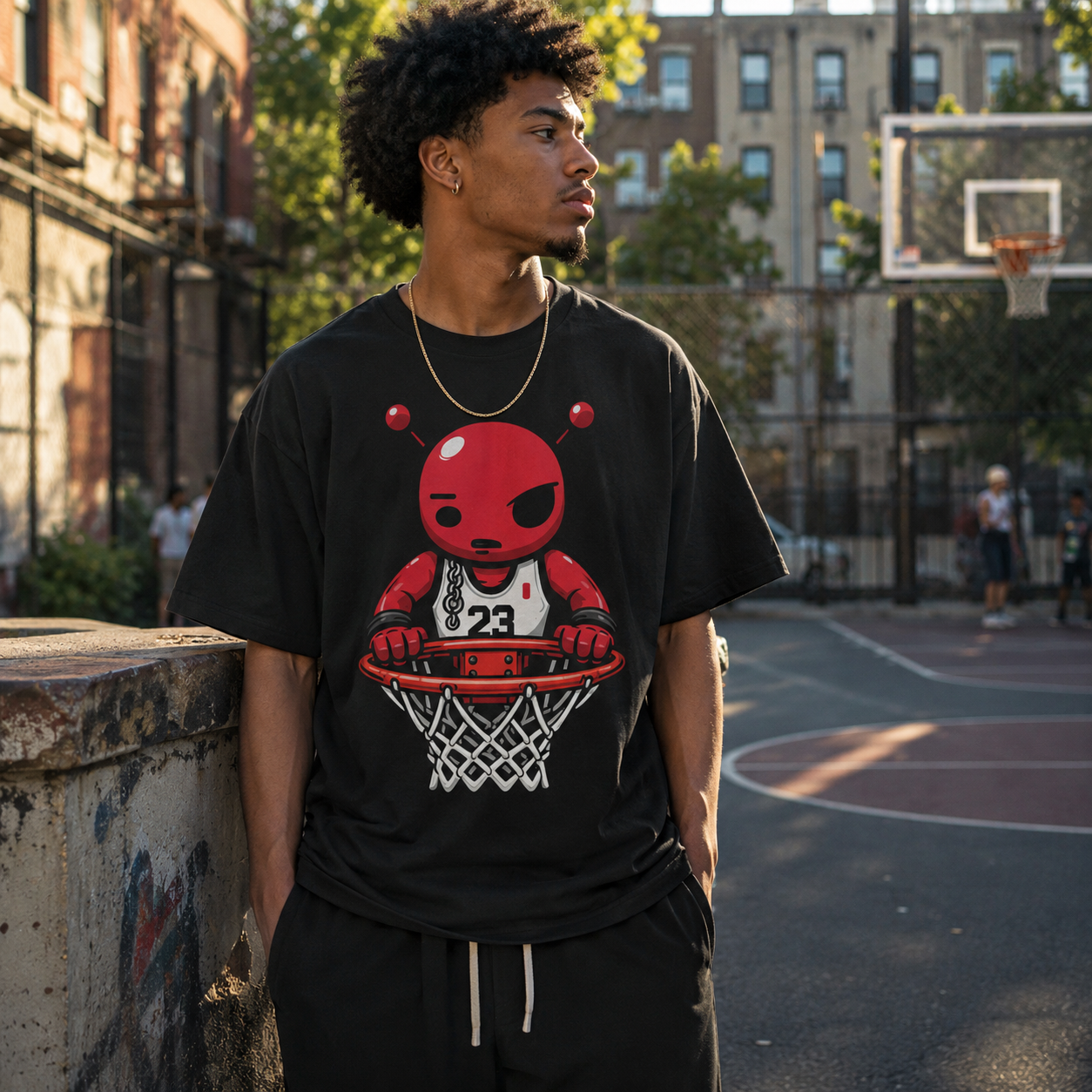 Person wearing a black t-shirt with a graphic design on a basketball court