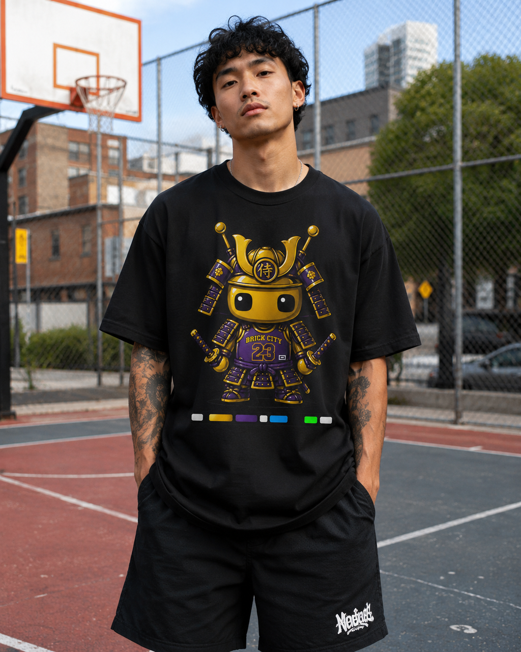 Person wearing a black t-shirt with a robot design on a basketball court