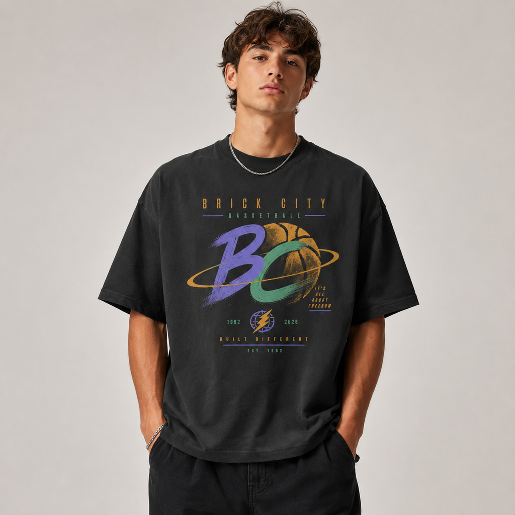 Person wearing a black t-shirt with colorful graphics and text on a plain background