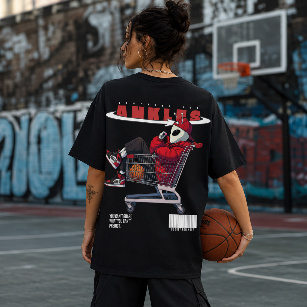 Person wearing a black t-shirt with a graphic design on a basketball court