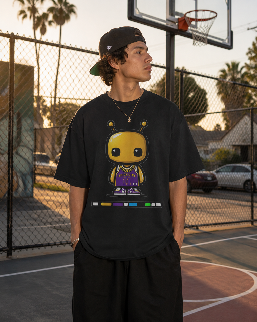 Person wearing a black t-shirt with a graphic design on a basketball court