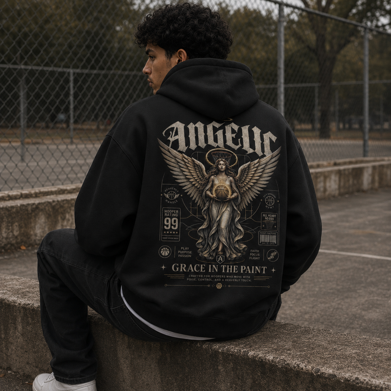 Grace in the Paint Oversized Hoodie black back print seated lifestyle