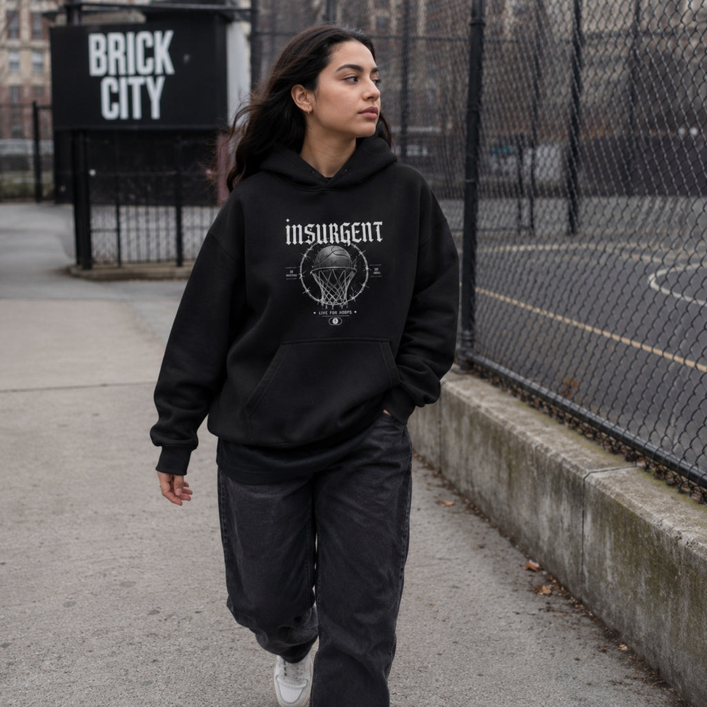 Woman wearing Insurgent basketball hoodie by the Brick City court sign