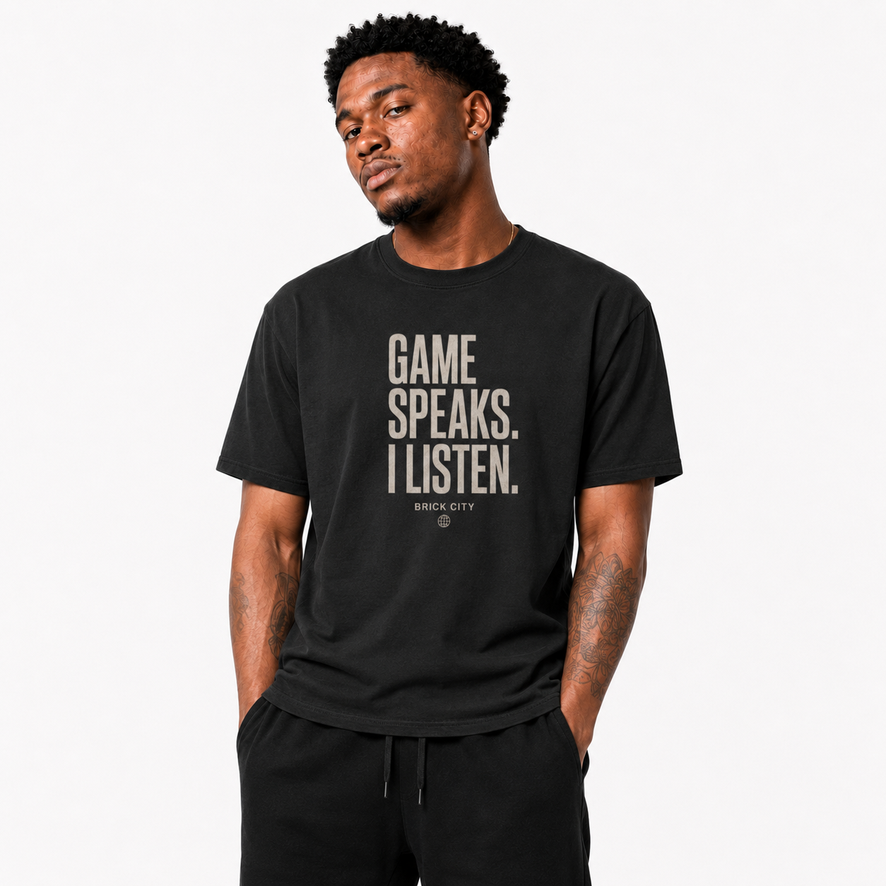 The Game Speaks, I Listen T-Shirt on Brick City model in studio view one