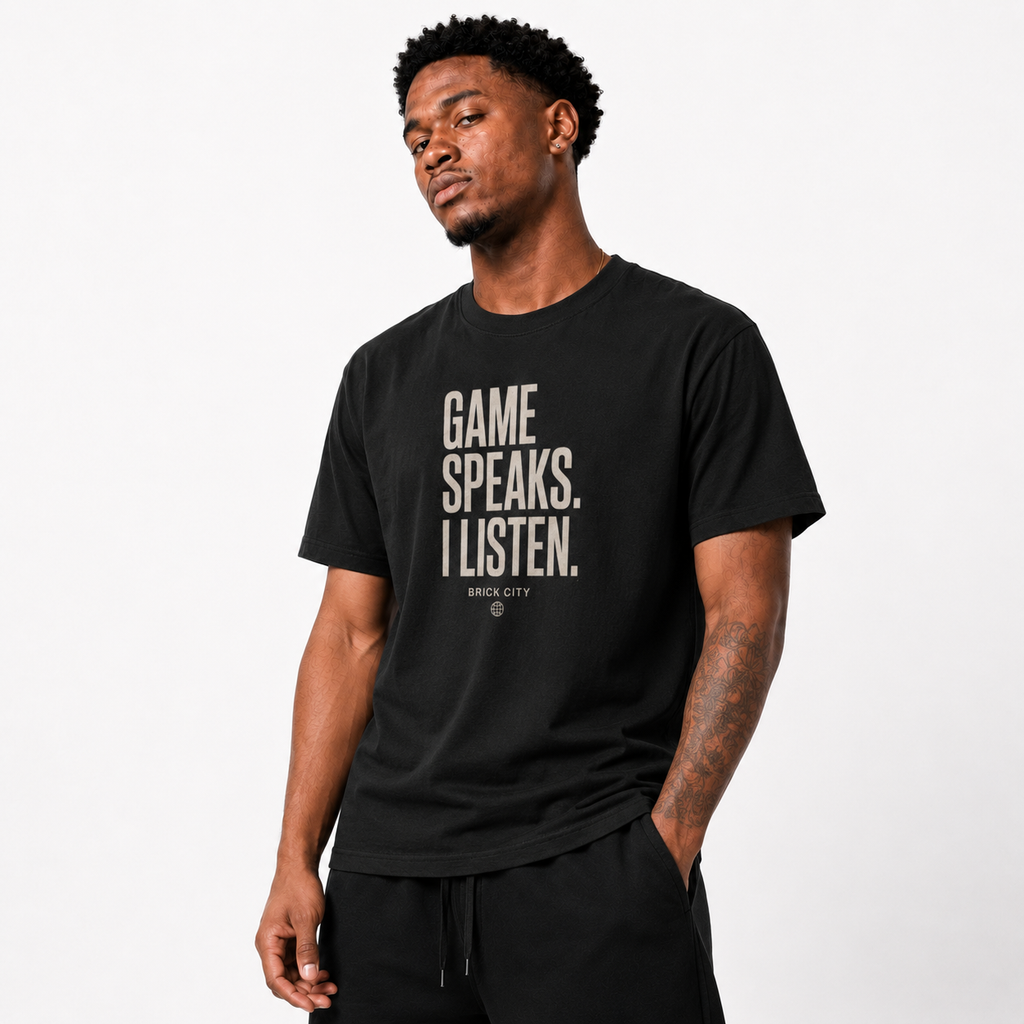 The Game Speaks, I Listen T-Shirt on Brick City model in studio view two