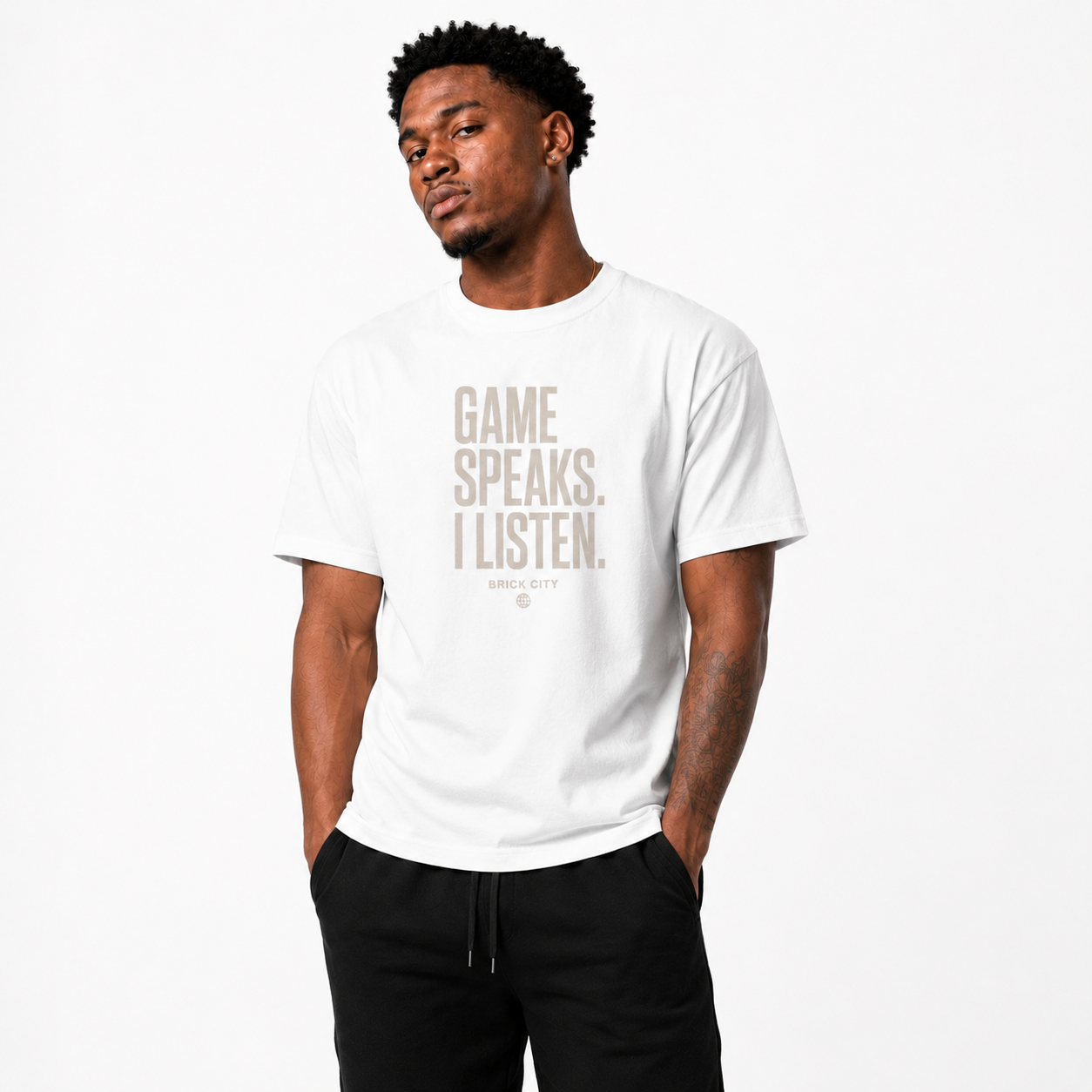 The Game Speaks, I Listen T-Shirt on Brick City model in studio view four